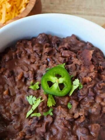 Refried black beans in a white bowl