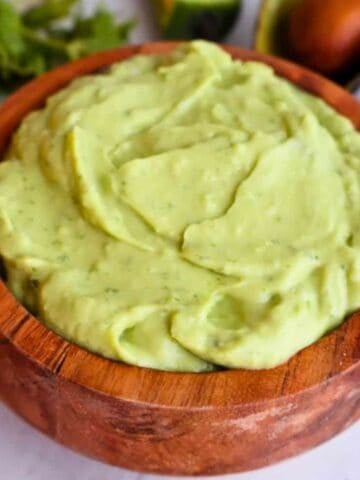 Guacamole sauce in a wooden bowl