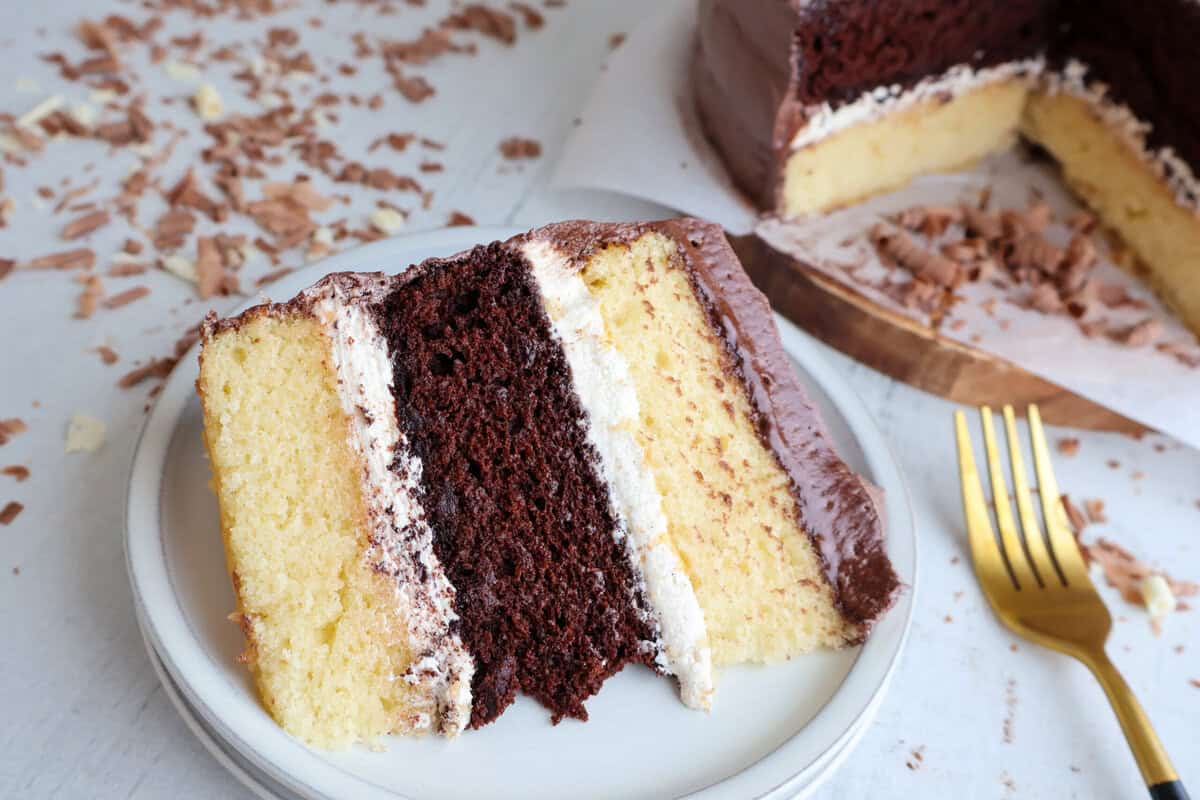 A finished slice of Gluten Free Dairy Free chocolate and vanilla cake.