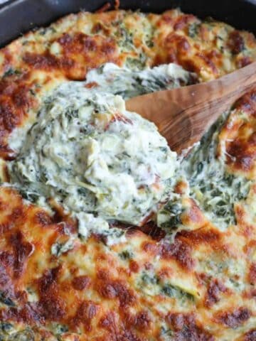 A skillet full of spinach dip.