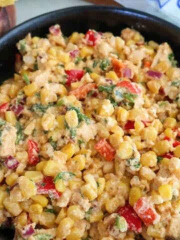Mexican corn chicken in a black bowl.