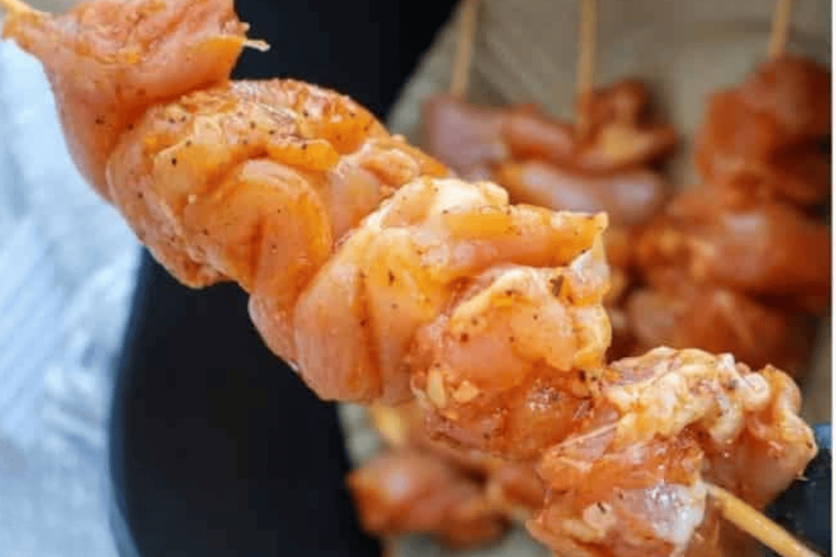 chicken cooking on a skewer