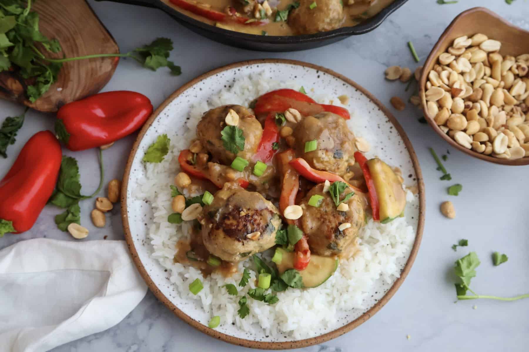 chicken meatballs in a white plate and with peppers
