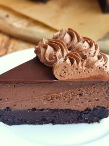 A slice of Nutella Brownie Cheesecake on a white plate.