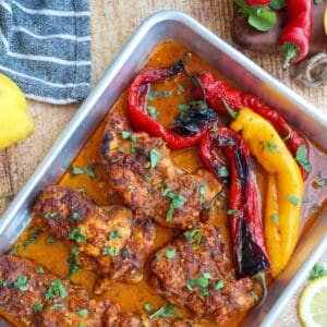 Overhead shot of baking sheet with chicken and peppers