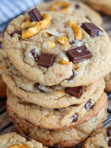 Stack of pretzel chocolate chip cookies on wire rack.