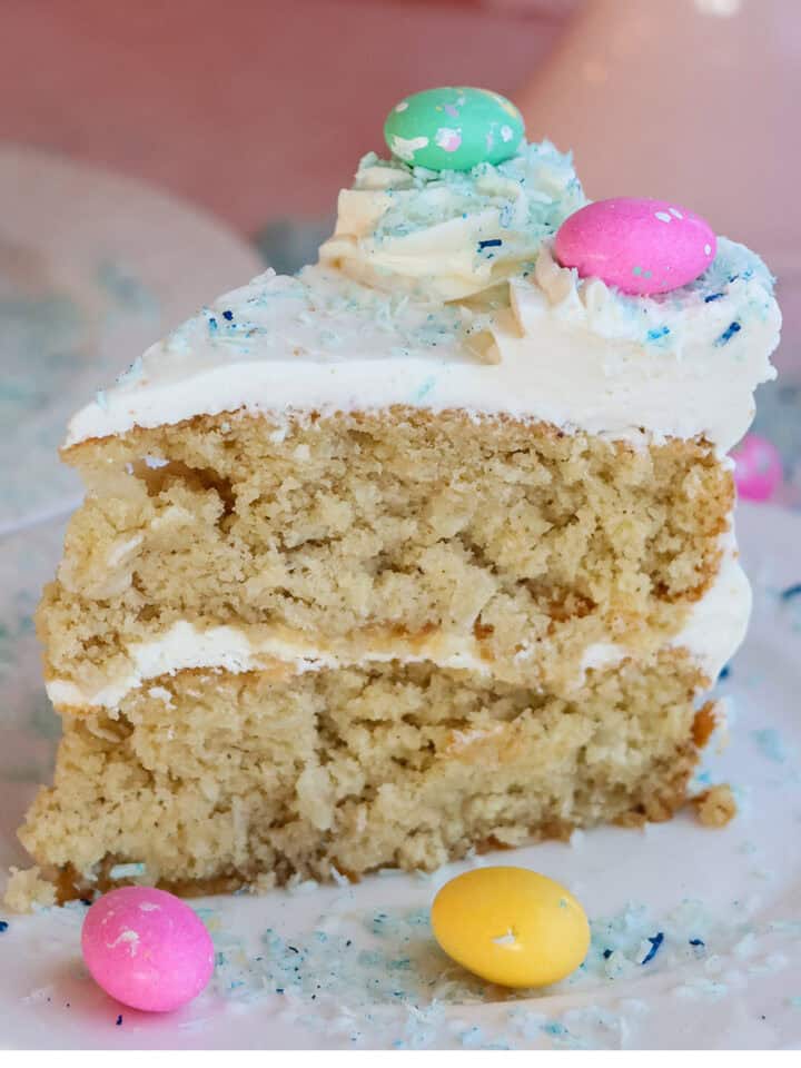 Slice of coconut cake on plate.
