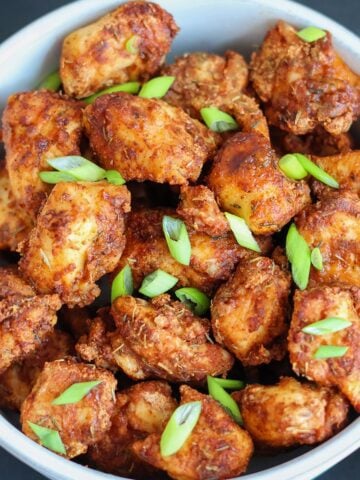 An overhead shot of a bowlful of air fried chicken bites.