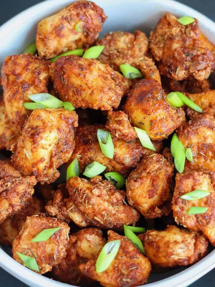 An overhead shot of a bowlful of air fried chicken bites.
