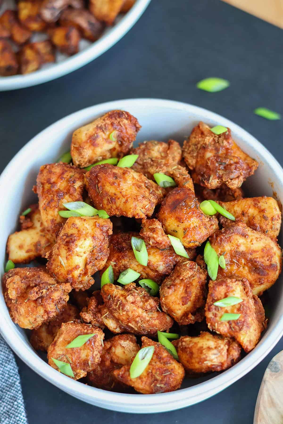 An overhead shot of a bowlful of crispy chicken bites.