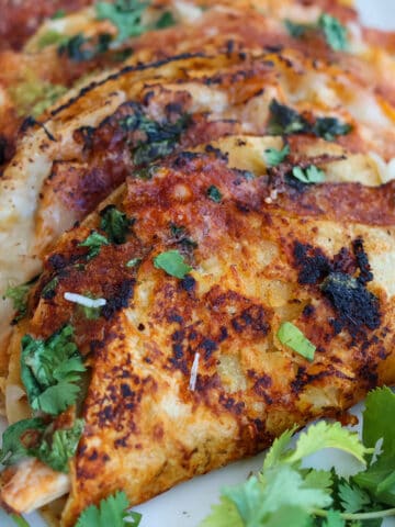 Plateful of crispy chicken tacos.