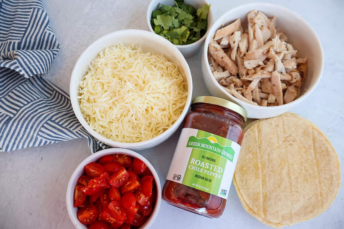 An overhead shot of taco ingredients in individual bowls. 