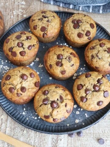 A plate of oatmeal chocolate chip muffins on a table.