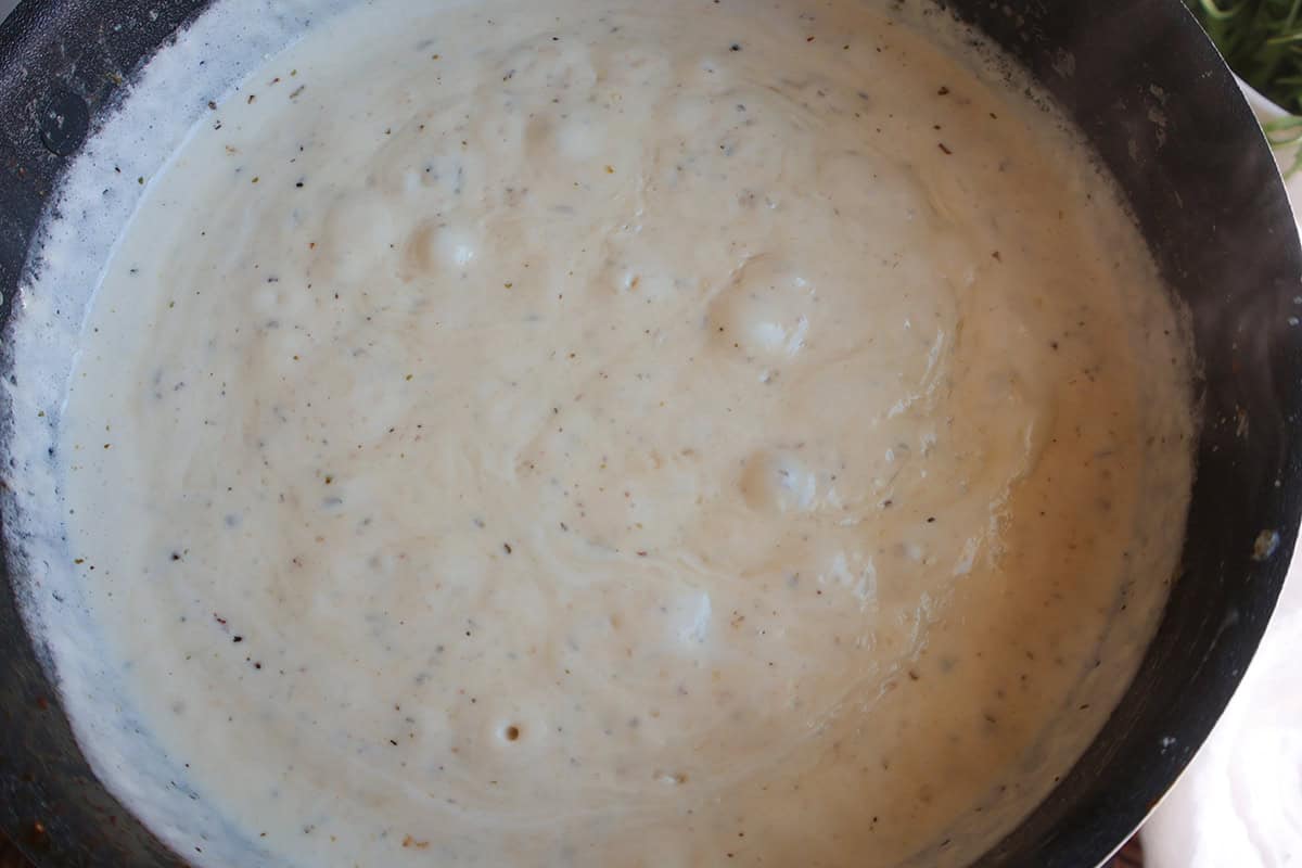 Creamy garlic parmesan sauce in a skillet.