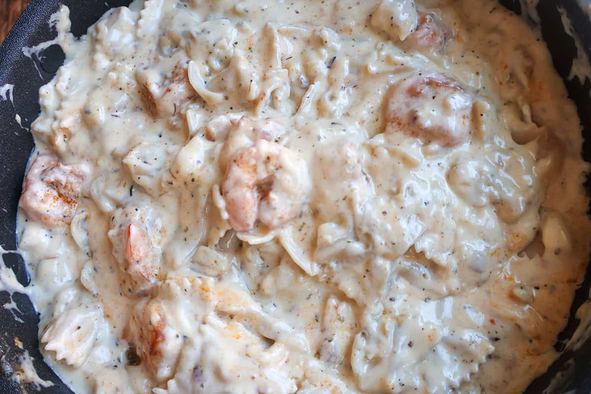 Creamy shrimp pasta in a skillet.