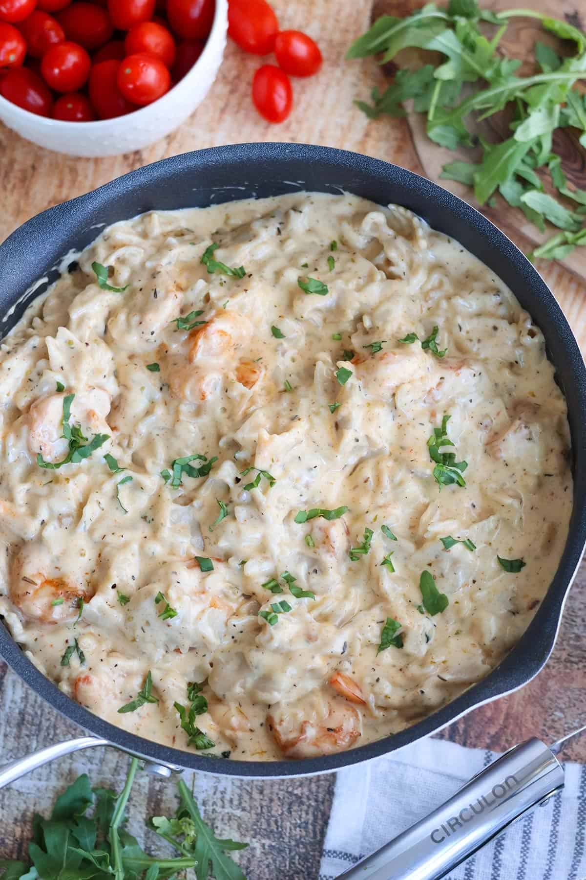 Creamy shrimp pasta in a skillet.