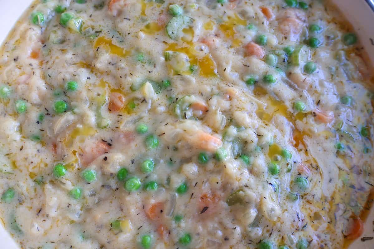 A skillet full of pot pie filling. 