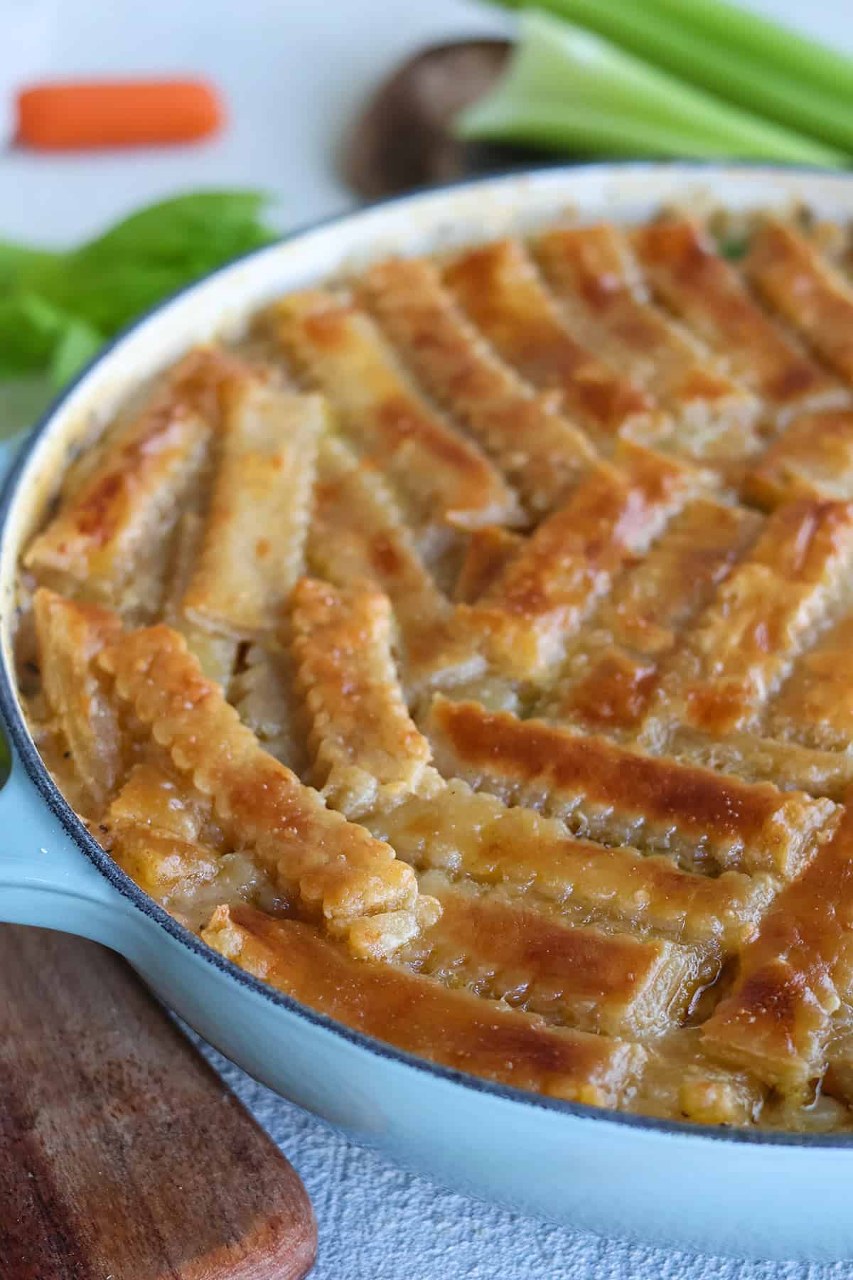 A skillet full of golden puff pastry chicken pot pie.