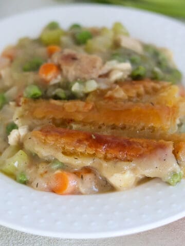 A white plate with turkey pot pie.