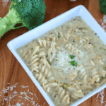 A bowl of Chicken Alfredo Soup with broccoli in the background.