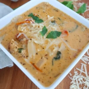 A white, square bowl filled with creamy soup.