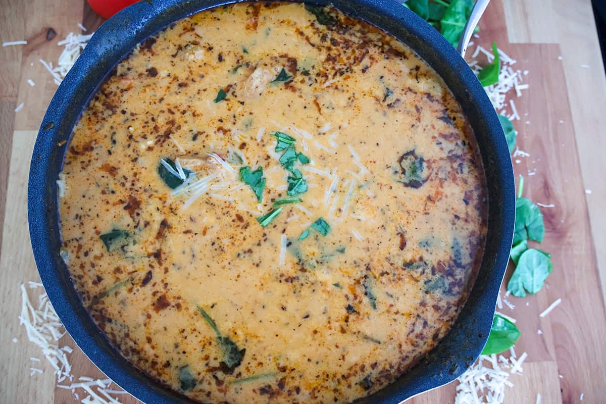 A skillet full of creamy chickenk soup.