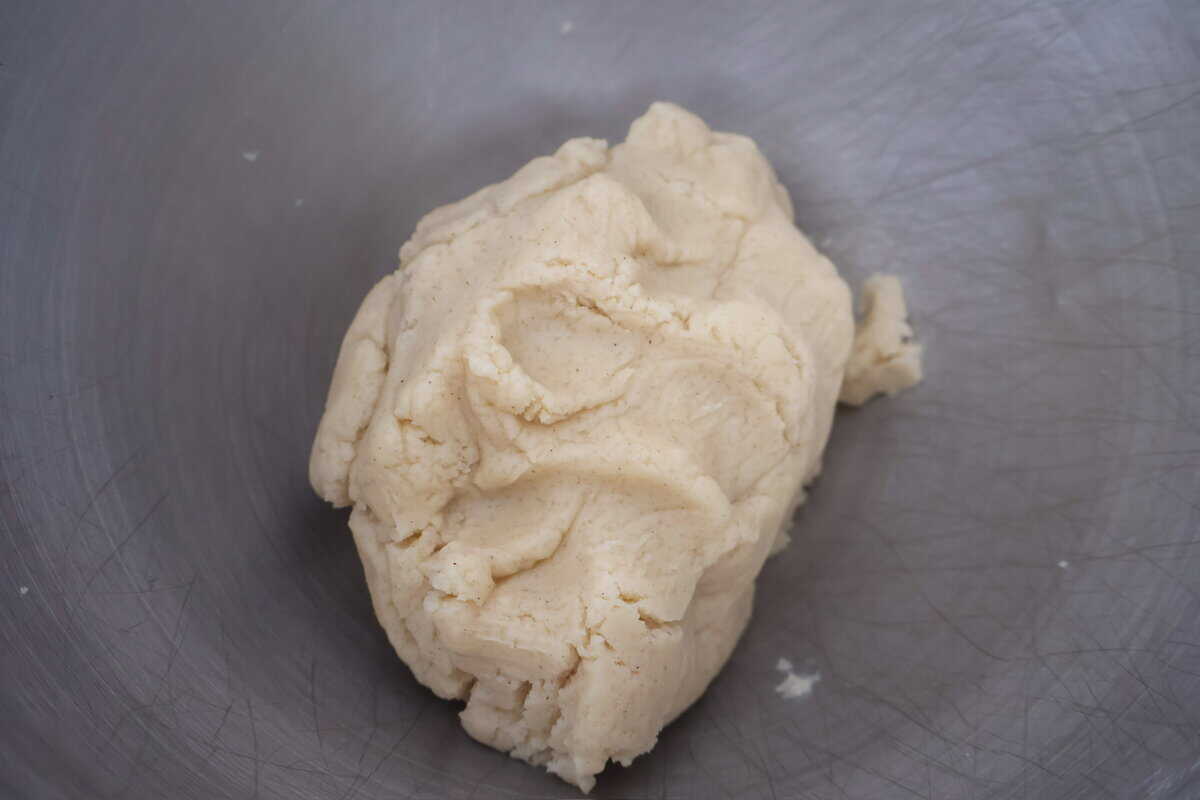 Raw sugar cookie dough in a mixing bowl ready to be formed.