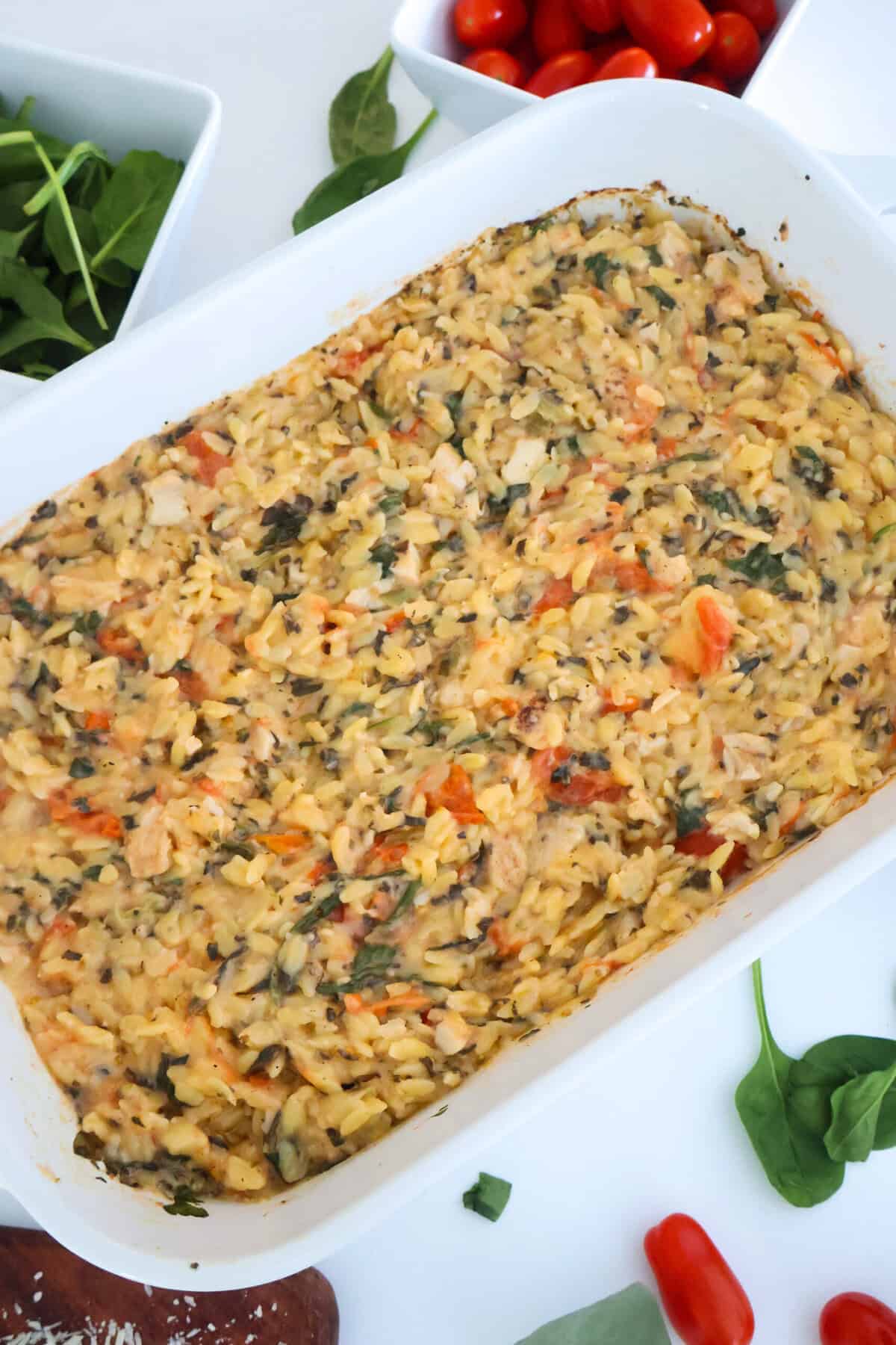 A baking dish of Spinach and Artichoke Orzo Pasta bake