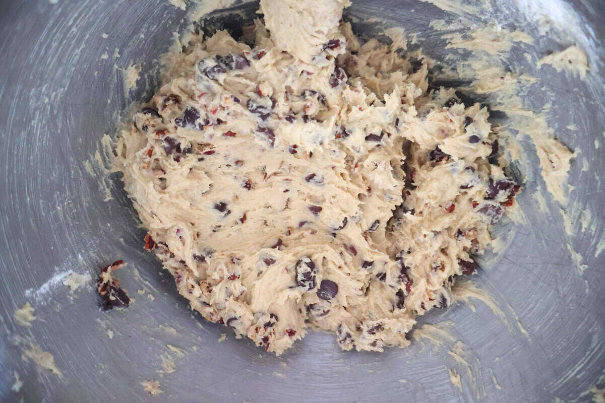 Pecan and Chocolate Chip Cookies batter in a metal bowl.