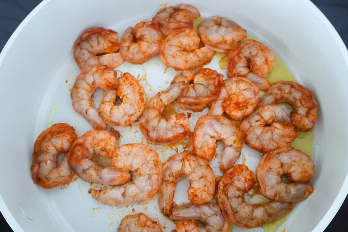 A bowl of seasoned shrimp ready to be cooked.