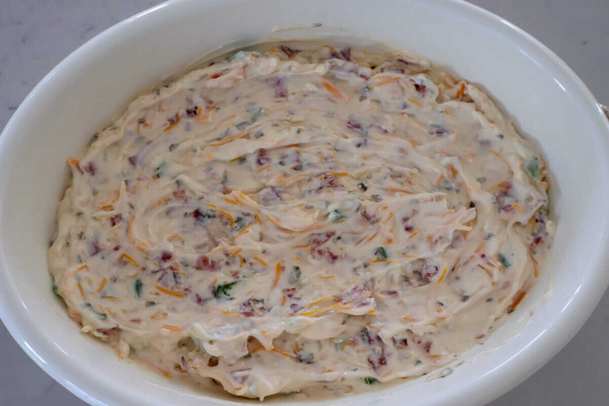 A casserole dish of raw jalapeño popper dip.