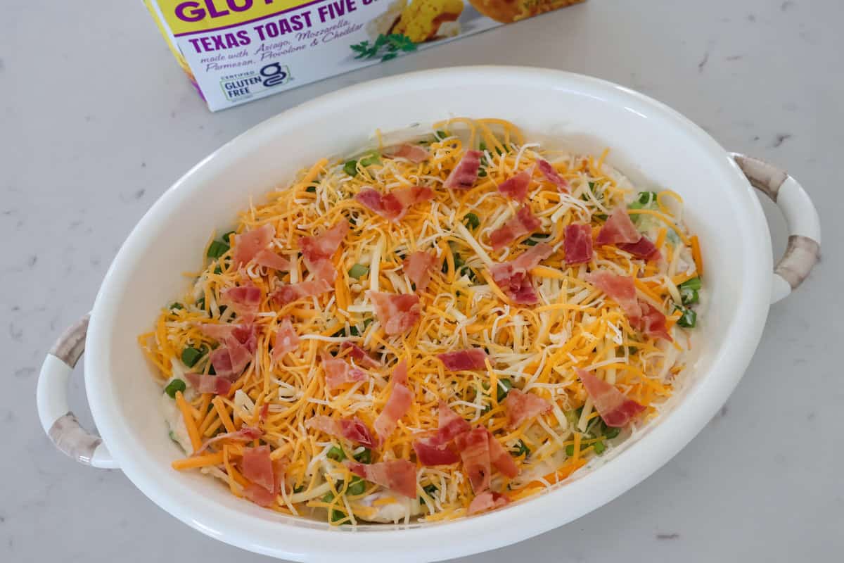 Jalapeño popper dip covered in cheese ready to be baked.