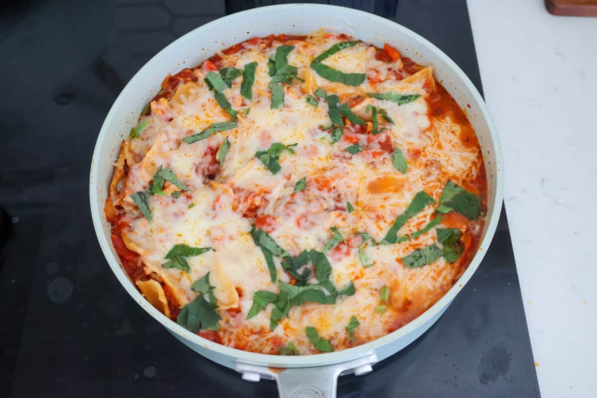 Lazy Lasagna in a saute pan topped with fresh basil.