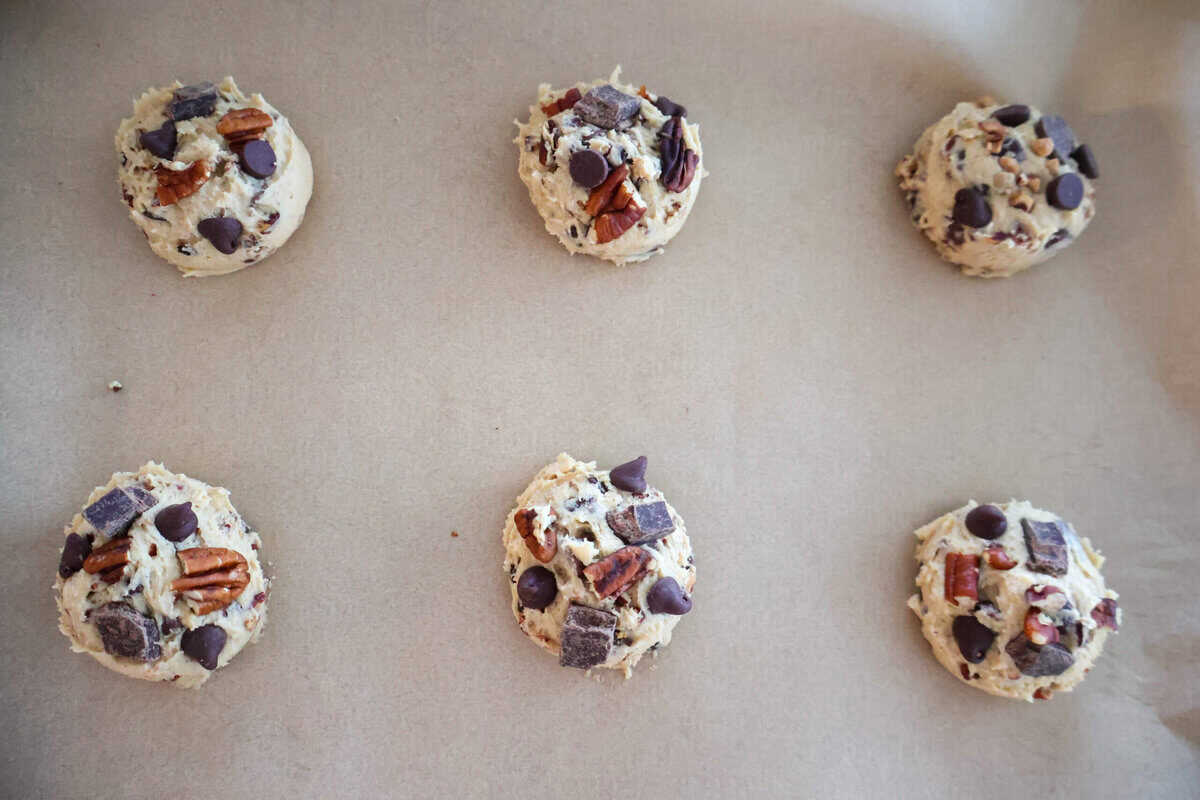 6 raw Pecan and Chocolate Chip Cookies on a tray.