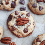 A Pecan and Chocolate Chip Cookie on a baking sheet.