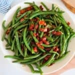 Green Beans with Bacon and Onions on a white plate.