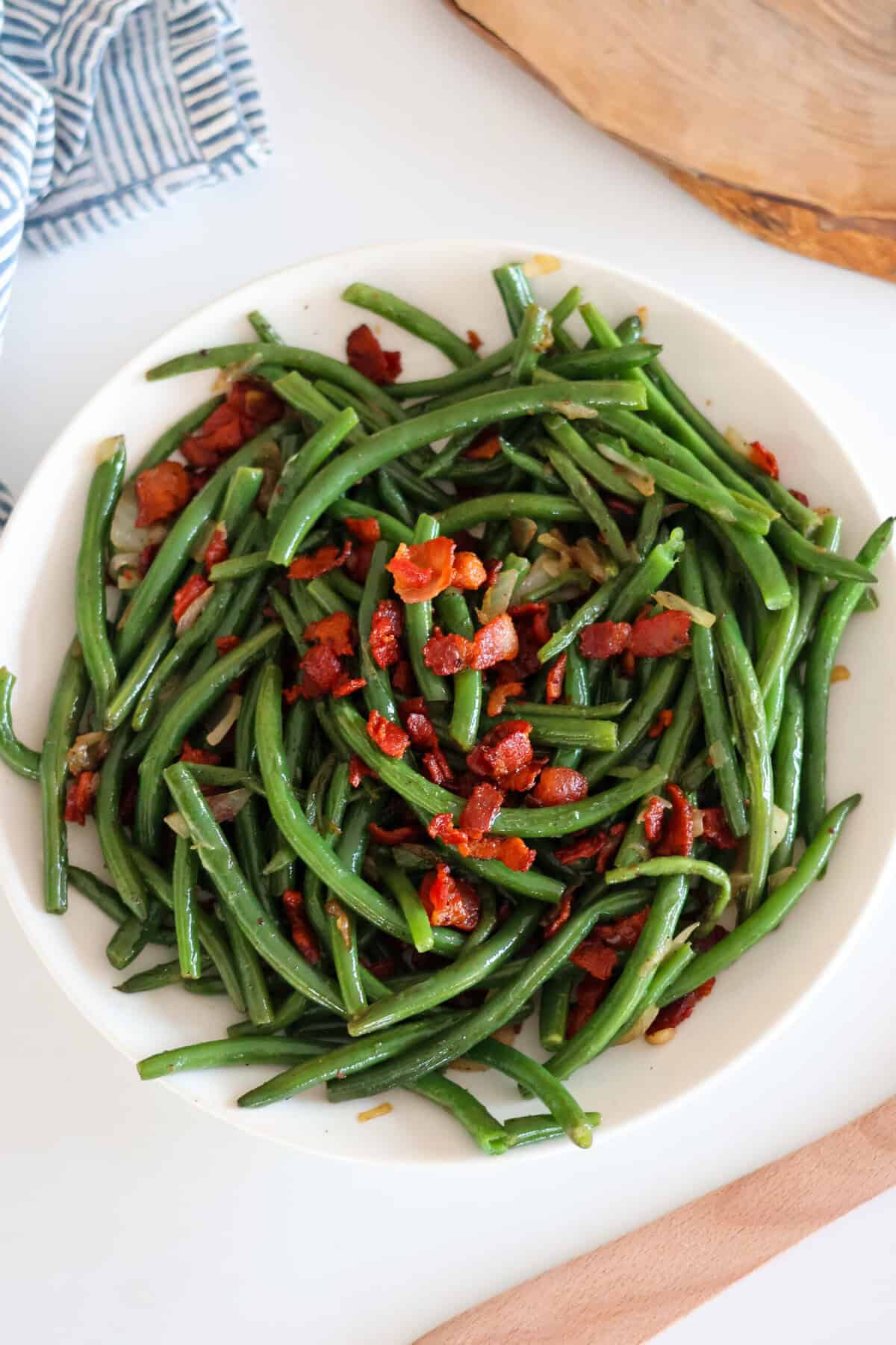 Green Beans with Bacon and Onions on a white plate.