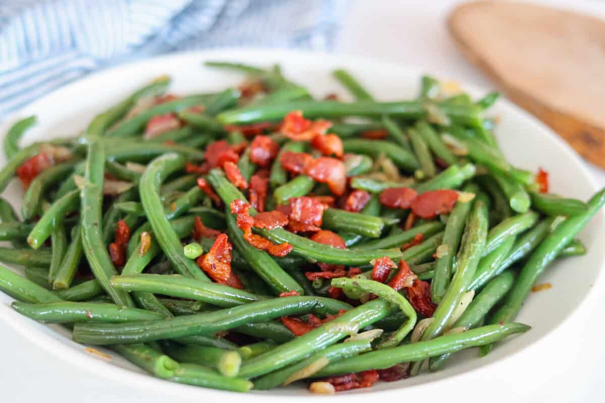 Green Beans with Bacon and Onions on a white plate.
