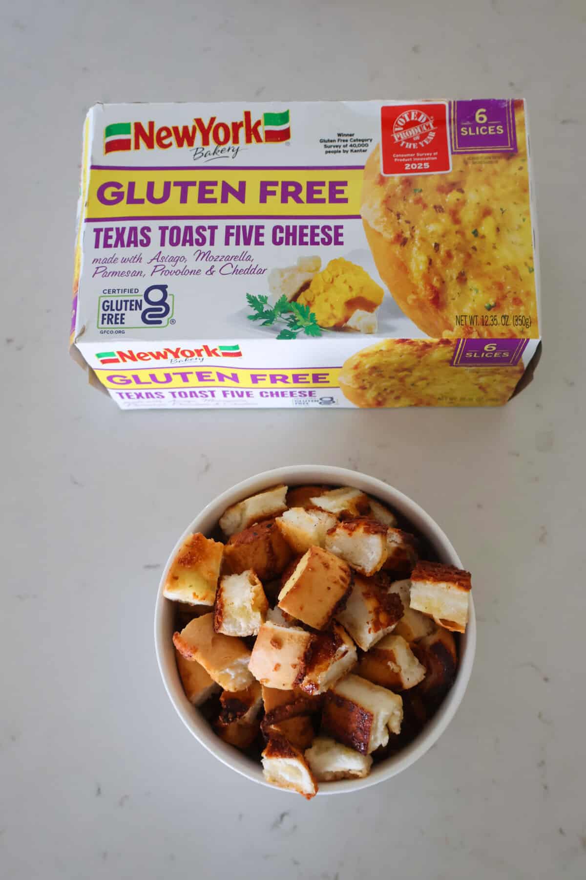 A bowl of croutons and a box of gluten free 5 cheese Texas Toast.