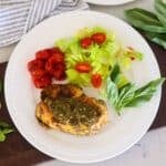 A plate of Grilled Chicken Pesto and a side salad and tomatoes