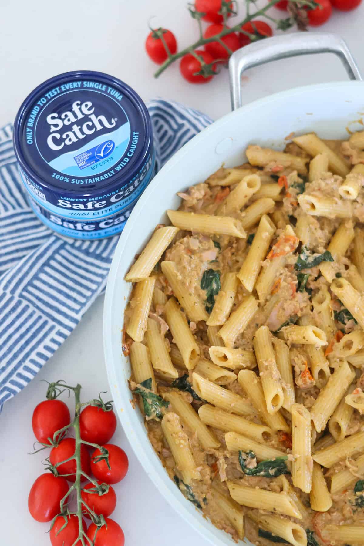A pan of Pasta with Pesto and Tuna next to a can of tuna.