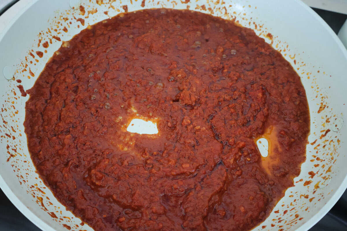 A sauce pan of Chorizo and tomato paste.