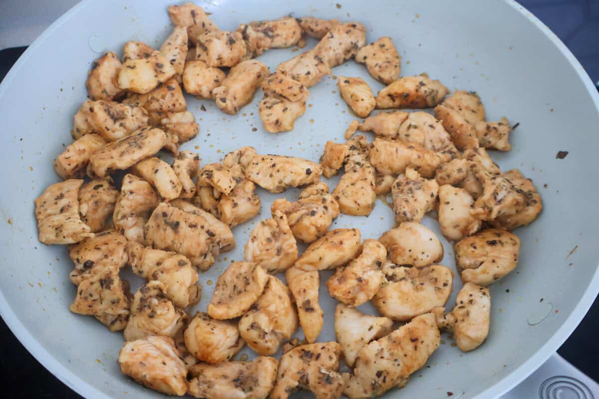 A saute pan of cooked chicken.