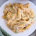 A white plate of Chicken Broccoli Penne Pasta.