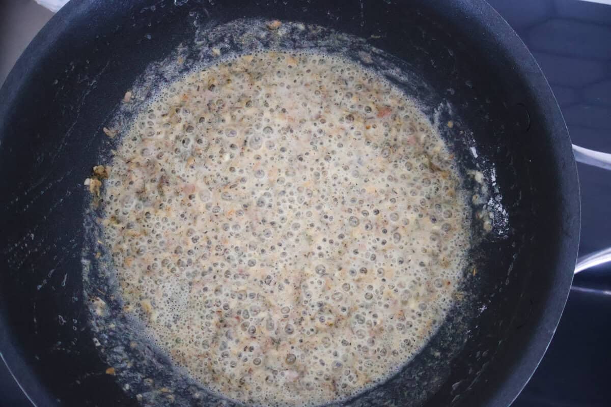 the start of Alfredo sauce simmering in a pan.