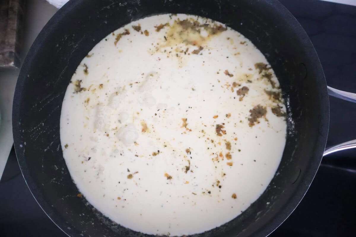 cream and cheese added to the base of a white sauce while on the stove.
