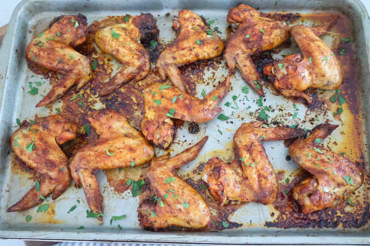 A sheet pan of oven baked whole chicken wings.