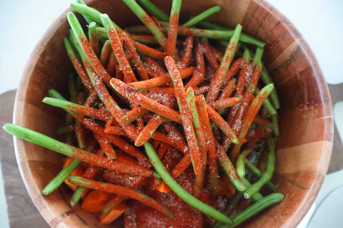 A wood bowl of seasoned green beans.