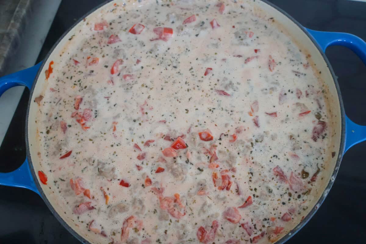 Creamy Sausage Pasta sauce cooking in a pan.