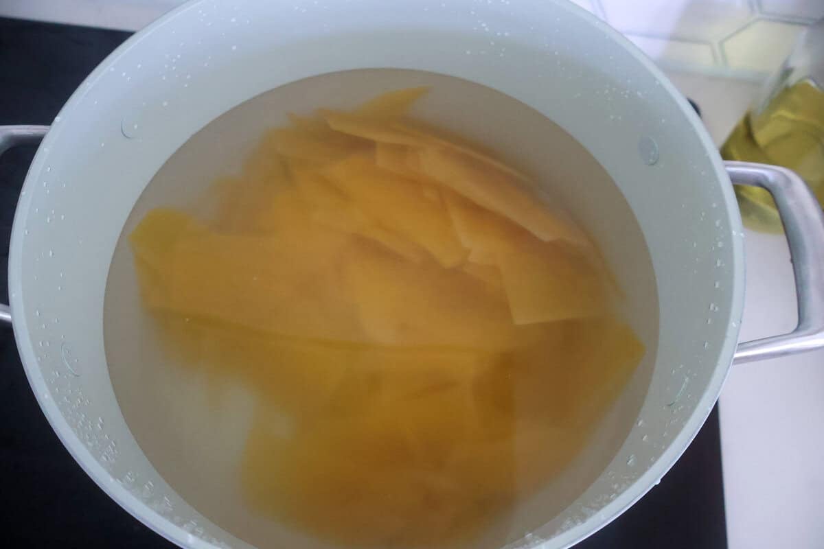 A pot of boiling water with pasta inside.